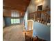 Open living room featuring a vaulted ceiling and wooden railing at 7140 N Michigan Rd, Fairland, IN 46126