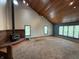 Inviting living room with a wood-burning stove, vaulted wood ceilings, and lots of natural light at 7140 N Michigan Rd, Fairland, IN 46126