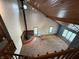 Spacious living room featuring a vaulted ceiling, wood accents, and a cozy fireplace viewed from top of stairs at 7140 N Michigan Rd, Fairland, IN 46126