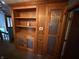 Built-in wooden bookcase, complete with decorative glass doors and accent lighting at 7140 N Michigan Rd, Fairland, IN 46126