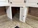 Under the kitchen sink is a storage area with a small white shutter door at 7140 N Michigan Rd, Fairland, IN 46126