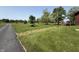 Exterior view of the house with a spacious yard and charming landscaping, plus a driveway leading to the home at 7140 N Michigan Rd, Fairland, IN 46126