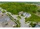 Aerial shot showcasing well-placed homes along a tree-lined street, surrounded by lush greenery at 7218 Antiquity Dr, Carmel, IN 46033