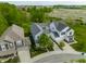 Aerial view of two-story homes with well-manicured lawns, driveways, and a glimpse of the surrounding neighborhood at 7218 Antiquity Dr, Carmel, IN 46033