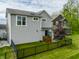 This modern home features a manicured backyard and black fence at 7218 Antiquity Dr, Carmel, IN 46033
