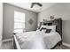 Comfortable bedroom features wood-look flooring, a ceiling fan, and bright, natural light at 7218 Antiquity Dr, Carmel, IN 46033