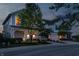 Charming two-story home with a welcoming front porch, well-manicured lawn, and an attached two-car garage at dusk at 7218 Antiquity Dr, Carmel, IN 46033