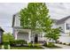 Two-story home with gray siding, white trim, covered porch and well-manicured landscaping at 7218 Antiquity Dr, Carmel, IN 46033