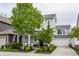 Charming two-story home featuring a covered front porch, attached garage, and well-manicured lawn at 7218 Antiquity Dr, Carmel, IN 46033