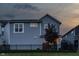 Exterior view showcases a home with a fenced backyard and a small tree, offering a cozy and private outdoor space at 7218 Antiquity Dr, Carmel, IN 46033