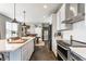 Stylish kitchen featuring a center island with seating, stainless steel appliances, and modern white cabinets at 7218 Antiquity Dr, Carmel, IN 46033