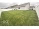 Large, well-maintained backyard with a lush green lawn, a white fence, and a glimpse of neighboring houses at 728 Jefferson Park Dr, Pittsboro, IN 46167