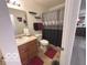 Traditional bathroom with a wood vanity, framed mirror, and a shower with silver curtain at 728 Jefferson Park Dr, Pittsboro, IN 46167