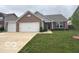Charming single-story home with a brick and siding exterior, an attached two-car garage, and a well-manicured lawn at 728 Jefferson Park Dr, Pittsboro, IN 46167