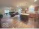 Open-concept living space with a kitchen island, dining area, and living room at 728 Jefferson Park Dr, Pittsboro, IN 46167