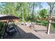 Beautiful back deck with a swing and fire pit surrounded by rocking chairs at 7626 Timber Springs S Dr, Fishers, IN 46038