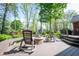 The spacious back deck features a fire pit area with seating and steps to the yard at 7626 Timber Springs S Dr, Fishers, IN 46038