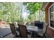 Lovely back deck area with outdoor dining set, grill and mature trees at 7626 Timber Springs S Dr, Fishers, IN 46038