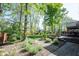 View of the backyard, which features a stone path leading to a raised deck area at 7626 Timber Springs S Dr, Fishers, IN 46038