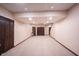 Large basement with neutral carpeting and dark wood doors at 7626 Timber Springs S Dr, Fishers, IN 46038