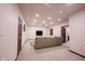 Spacious finished basement with a large sofa and a flat-screen TV for entertainment at 7626 Timber Springs S Dr, Fishers, IN 46038