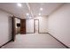 Unfinished basement area features neutral carpeting and dark wood doors at 7626 Timber Springs S Dr, Fishers, IN 46038