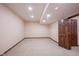 Spacious basement area featuring neutral carpeting and a solid wood door at 7626 Timber Springs S Dr, Fishers, IN 46038