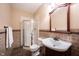 Well-maintained bathroom features a glass shower and large mirror at 7626 Timber Springs S Dr, Fishers, IN 46038