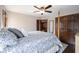 Large bedroom featuring a four-poster bed with blue patterned bedding and hardwood floors at 7626 Timber Springs S Dr, Fishers, IN 46038