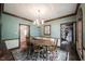 Traditional dining room with a chandelier, hardwood floors, and wood trim at 7626 Timber Springs S Dr, Fishers, IN 46038