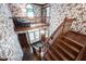 An ornate foyer features hardwood floors and staircase, floral wallpaper, and a clerestory window at 7626 Timber Springs S Dr, Fishers, IN 46038