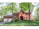 Beautiful red brick two-story home with mature landscaping and a two car attached garage at 7626 Timber Springs S Dr, Fishers, IN 46038