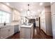 Bright kitchen with an island, stainless appliances, granite countertops, and hardwood floors at 7626 Timber Springs S Dr, Fishers, IN 46038