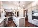Eat in kitchen with granite countertops, hardwood floors, an island and stainless appliances at 7626 Timber Springs S Dr, Fishers, IN 46038