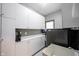 Laundry room featuring white cabinets, sink, and counter space at 7626 Timber Springs S Dr, Fishers, IN 46038