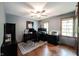 Office space featuring modern computer setup, a ceiling fan, and natural light from large windows at 7626 Timber Springs S Dr, Fishers, IN 46038