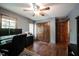 Office with hardwood floors, modern computer setup, large window, and ceiling fan at 7626 Timber Springs S Dr, Fishers, IN 46038