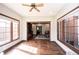 Hardwood floors and many windows bring the outside in for this light filled sunroom at 7626 Timber Springs S Dr, Fishers, IN 46038