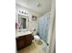 Cozy bathroom featuring a patterned shower curtain, neutral vanity, and whimsical animal artwork at 7804 Amadeus Dr, Indianapolis, IN 46239