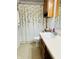 Bathroom features wood vanity, floral shower curtain, and modern toilet at 7804 Amadeus Dr, Indianapolis, IN 46239