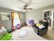 Spacious bedroom with a ceiling fan, grey walls, and filled with toys at 7804 Amadeus Dr, Indianapolis, IN 46239