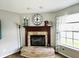 Classic brick fireplace with decorative mantel, perfect for creating a warm and inviting atmosphere at 7804 Amadeus Dr, Indianapolis, IN 46239