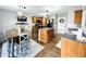 Open kitchen with wood cabinets, stainless steel appliances, center island, and view of the dining area at 7804 Amadeus Dr, Indianapolis, IN 46239