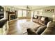 Cozy living room with hardwood floors, a classic brick fireplace, and ample seating at 7804 Amadeus Dr, Indianapolis, IN 46239