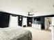 Modern main bedroom features a ceiling fan, natural light, and white dresser at 7804 Amadeus Dr, Indianapolis, IN 46239
