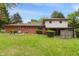 Home featuring a brick exterior, covered patio, and spacious backyard, perfect for outdoor activities at 8140 Valley Estates Dr, Indianapolis, IN 46227