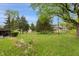 Spacious backyard with mature trees providing shade and privacy at 8140 Valley Estates Dr, Indianapolis, IN 46227