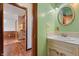 Bathroom featuring a vanity sink with decorative accents and an open doorway, offering a charming and functional space at 8140 Valley Estates Dr, Indianapolis, IN 46227
