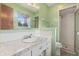 Bathroom featuring a vanity sink with marble countertop and a shower, offering convenience and style at 8140 Valley Estates Dr, Indianapolis, IN 46227