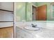 Bathroom features vanity sink with white marble-look countertop and an open doorway, connecting to additional rooms at 8140 Valley Estates Dr, Indianapolis, IN 46227